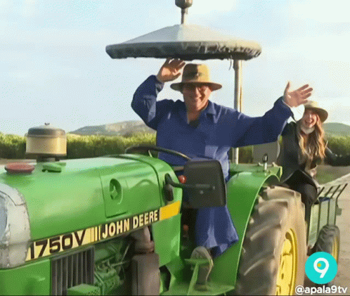 Man In Blue Shirt Driving John Deere Tractor GIF