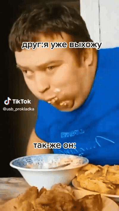 Man In Blue Shirt Eating From Bowl With Spoon GIF