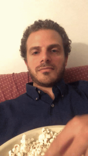 Man In Blue Shirt Eating Popcorn GIF