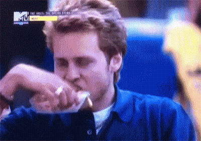 Man In Blue Shirt Eating Sandwich GIF