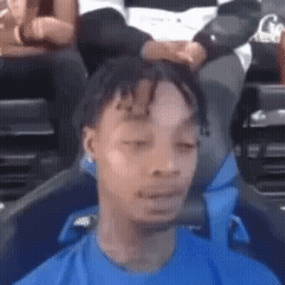 Man In Blue Shirt Eyes Closed Funny Face In Stadium GIF
