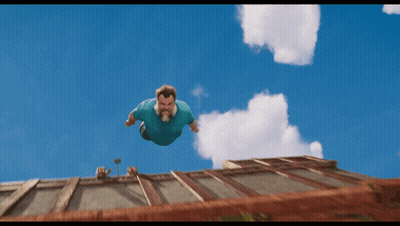 Man In Blue Shirt Flying Above Building GIF