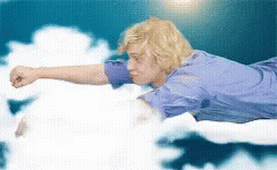 Man In Blue Shirt Flying With Arm Outstretched GIF