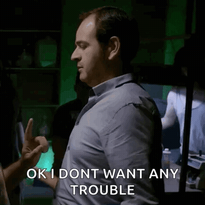 Man in Blue Shirt Giving Middle Finger Saying OK I Dont Want Any Trouble