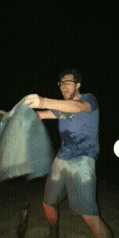 Man In Blue Shirt Holding Blue Cloth GIF