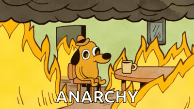 Man In Blue Shirt Holding Chainsaw And Gun GIF