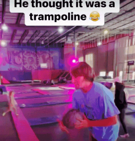 Man In Blue Shirt Holding Child On Trampoline Saying He Thought It Was A Trampoline GIF