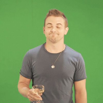 Man in Blue Shirt Holding Glass of Wine