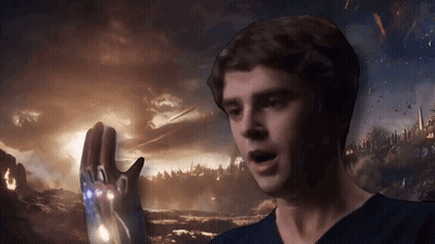 Man In Blue Shirt Holding Glowing Iron Man Glove GIF