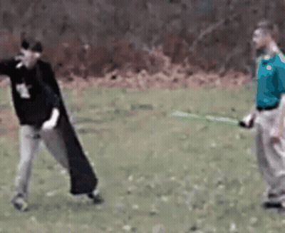 Man In Blue Shirt Holding Green Sword GIF