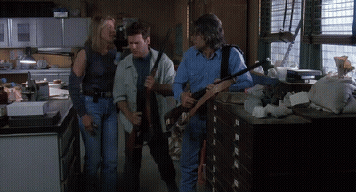 Man In Blue Shirt Holding Gun GIF