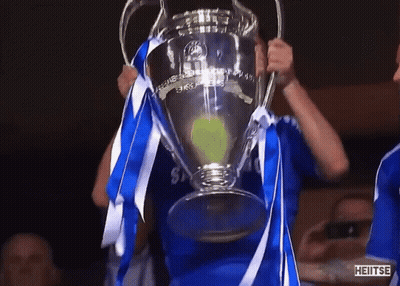 Man In Blue Shirt Holding Heitse Trophy GIF