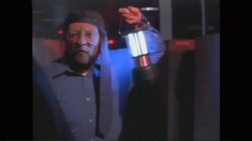 Man In Blue Shirt Holding Lantern GIF