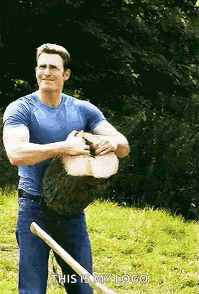 Man In Blue Shirt Holding Log And Shovel GIF