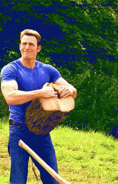 Man In Blue Shirt Holding Log And Shovel GIF