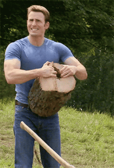 Man in Blue Shirt Holding Log and Shovel