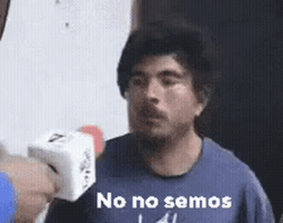 Man In Blue Shirt Holding Microphone Saying No No Semos GIF