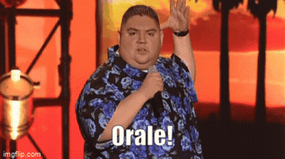 Man In Blue Shirt Holding Microphone Saying Orale GIF