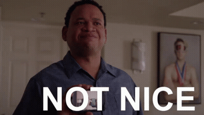 Man In Blue Shirt Holding Not Nice Card GIF