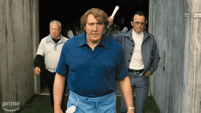 Man In Blue Shirt Holding Paper In Front Of Prime Sign GIF