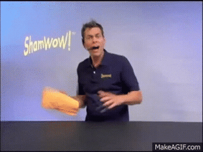 Man In Blue Shirt Holding Paper Saying Shamwow GIF