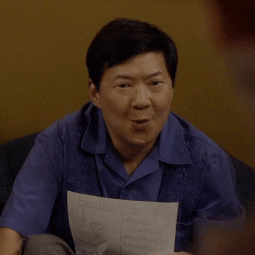 Man In Blue Shirt Holding Paper Saying Triumph GIF