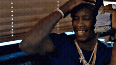Man In Blue Shirt Holding Pile Of Money GIF