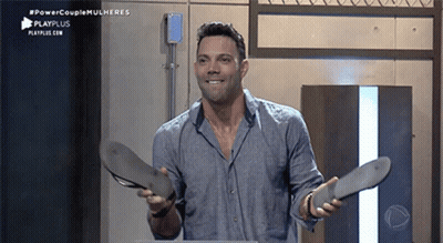 Man In Blue Shirt Holding Sandals GIF