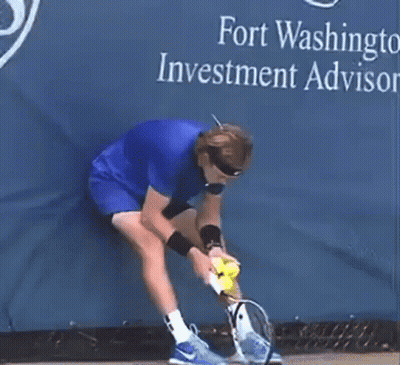 Man In Blue Shirt Holding Tennis Racket And Ball GIF