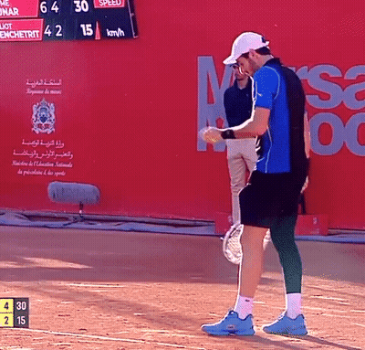 Man in Blue Shirt Holding Tennis Racquet