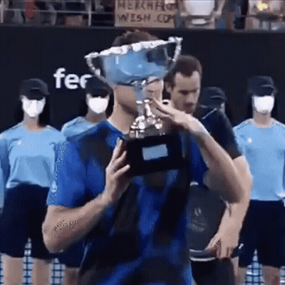 Man In Blue Shirt Holding Trophy GIF