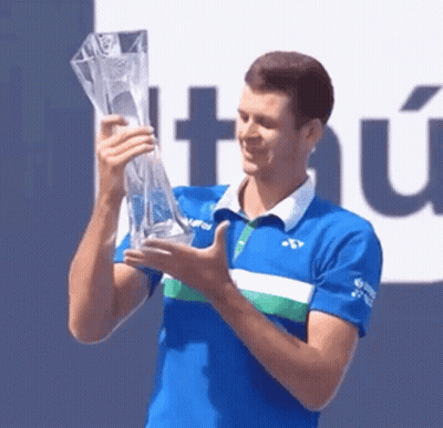 Man In Blue Shirt Holding Trophy GIF