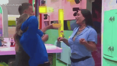 Man In Blue Shirt Holding Woman In Kitchen GIF