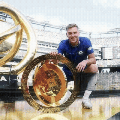 Man In Blue Shirt Holding World Cup Trophy GIF