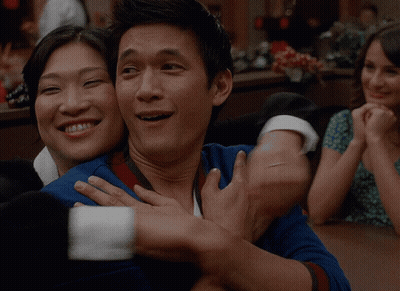 Man In Blue Shirt Hugging Woman In Green Dress GIF