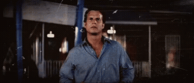 Man In Blue Shirt In Front Of Building GIF
