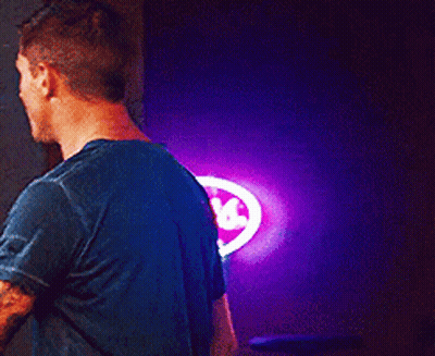 Man In Blue Shirt In Front Of Coors Sign GIF