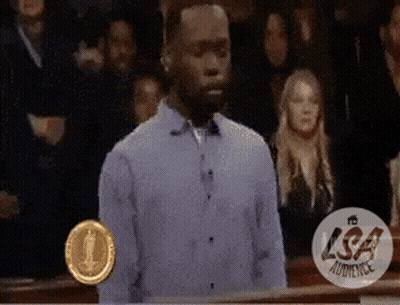 Man In Blue Shirt In Front Of Crowd With LSA Audience Logo GIF
