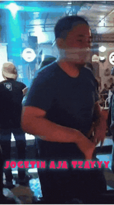 Man In Blue Shirt In Front Of Dogetin A Tasty Sign GIF