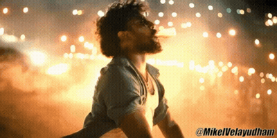 Man In Blue Shirt In Front Of Fireworks GIF