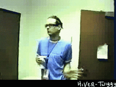 Man In Blue Shirt In Front Of Hiver-Twigg Door GIF