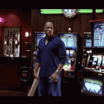 Man In Blue Shirt In Front Of Lucky Strike Slot Machine GIF