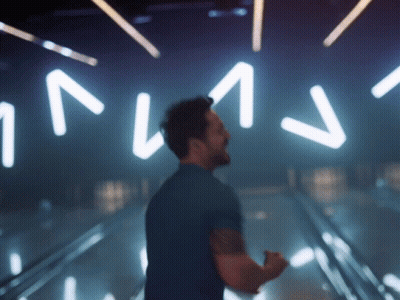 Man In Blue Shirt In Front Of NV Sign GIF