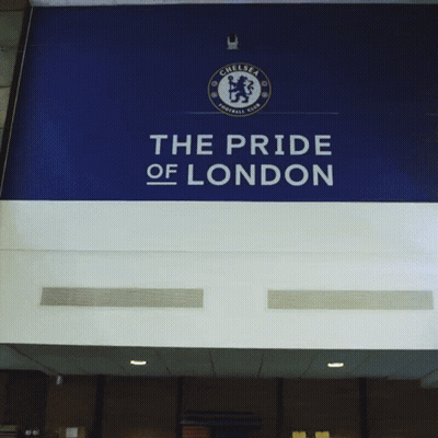 Man In Blue Shirt In Front Of Pride Of London Sign GIF