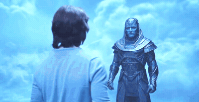Man In Blue Shirt In Front Of Statue GIF