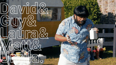 Man In Blue Shirt In Front Of Trailer With David Guy Laura Matt GIF