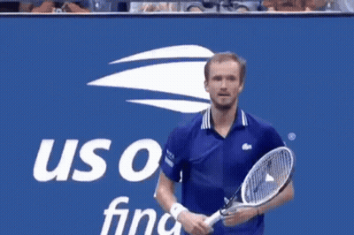 Man in Blue Shirt in Front of US Open Final Sign