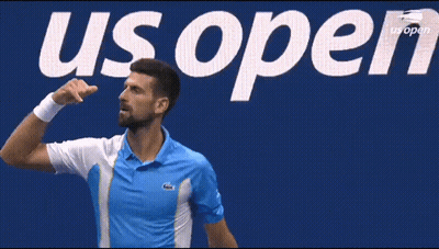 Man In Blue Shirt In Front Of US Open Sign GIF