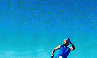 Man In Blue Shirt Jumping In The Air GIF