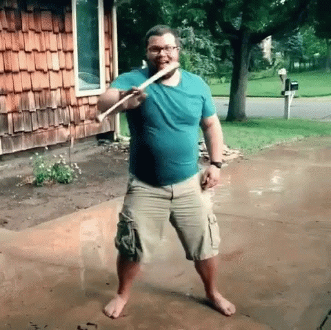 Man In Blue Shirt Khaki Shorts With Stick GIF